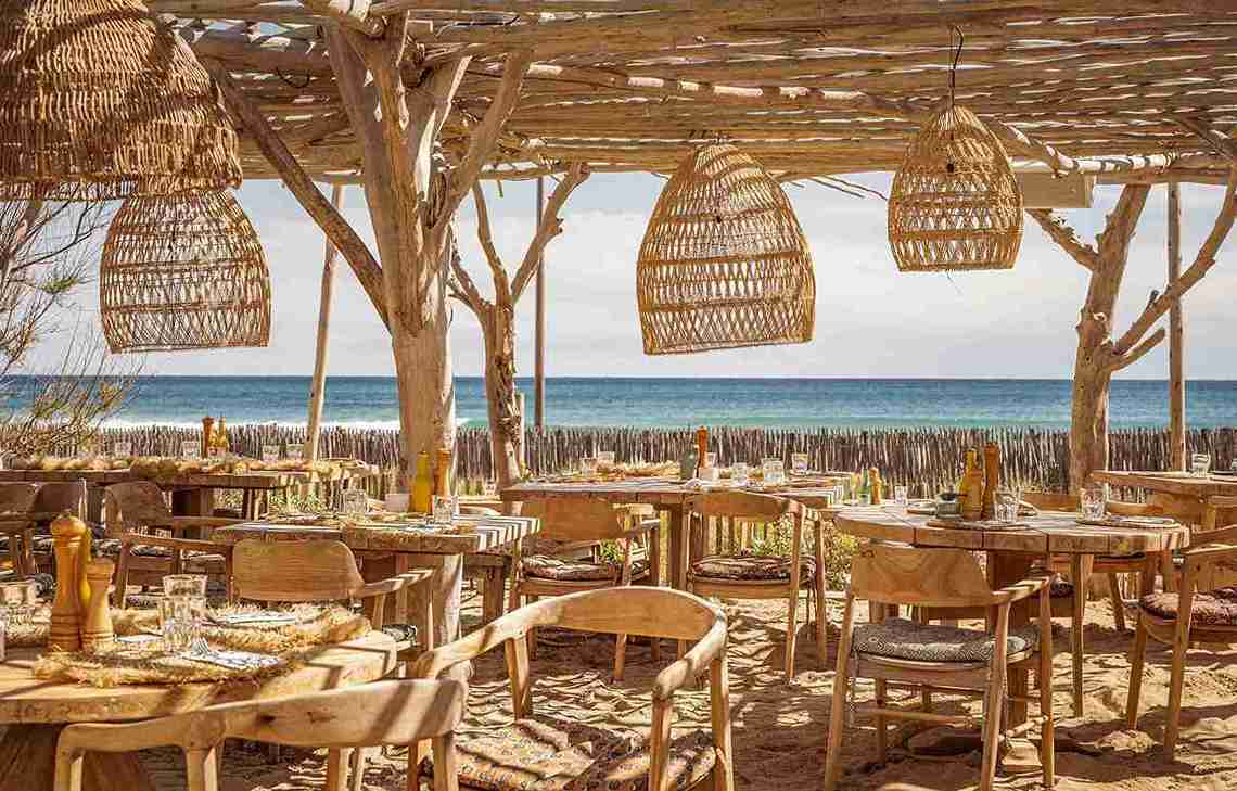 Cabane Bambou dining space with bamboo ceiling and furniture