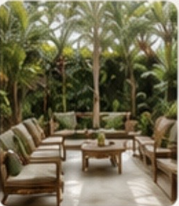 Outdoor furniture pieces surrounded by tropical greenery